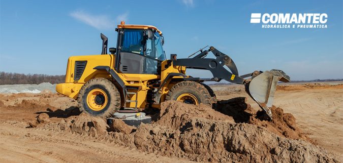 bulldozer-or-loader-moves-the-earth-at-the-construction-site-against-the-blue-sky-an-earthmoving-machine-is-leveling-the-site-construction-heavy-equipment-for-earthworks